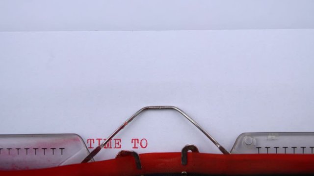 Time to say goodbye - phrase printed on an old typewriter in red letters, close up. vintage inscription
