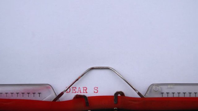 Dear Santa Claus - phrase printed on an old typewriter in red letters, close up. vintage inscription. Letter to Santa