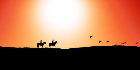 Fototapeta na wymiar Young people riding horses at sunset time - Horseback travel people having fun exploring wild nature - Animals passion and equestrian lifestyle concept