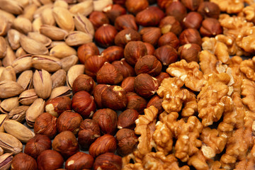 hazelnut, walnut and pistachio nut. mixed assorted nuts in glass box on light background.