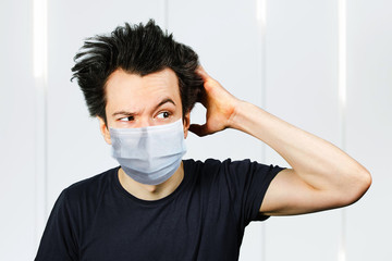 mad young man think, wearing a protective face mask prevent virus infection or pollution