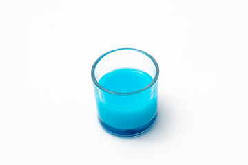 Blue drink in a glass with white background