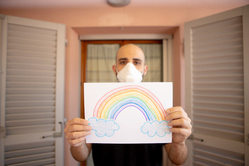 Caucasian man with virus mask and colorful rainbow, in epidemic period. Human prevention by Covid-19, pandemic coronavirus from China. Security concept from virus
