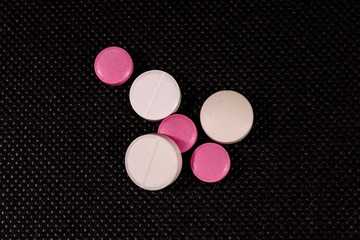Antibiotic pills on a black background. Healthcare and medicine concept