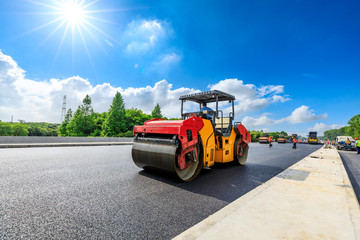 Construction site is laying new asphalt road pavement,road construction workers and road...