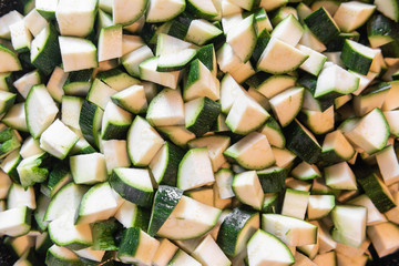 Zucchini ( courgettes) cut into small pieces. Background or texture