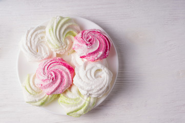 Homemade sweet colored meringue on white background.  .Dessert.