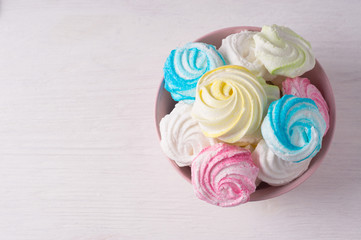 Homemade sweet colored meringue on white background.  .Dessert.