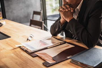 Businessman with chart in the fall. economy or stock market going down. Business man serious a...
