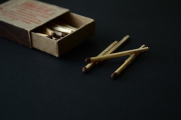 old box of matches on a dark background