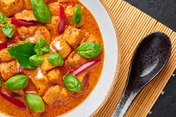 Thai Panang Chicken Curry in white plate. Phanaeng Curry is thai cuisine dish with chicken, kaffir lime leaves, red curry sauce and vegetables. Thai food. Thailand meal. Close up