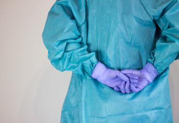 Rear view of male nurse dressed in coronavirus protection equipment.