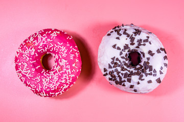 Fresh glazed donuts isolated on a pink background