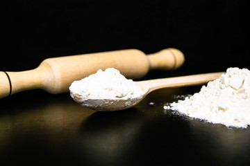 Flour, rolling pin, wooden spoon