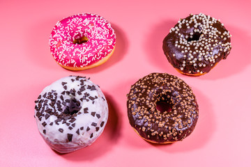 Fresh glazed donuts isolated on a pink background