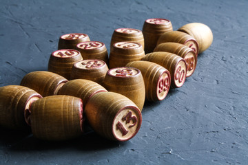 Vintage Lotto barrels are arranged in random order on a dark surface.