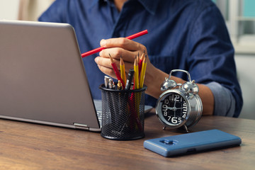 Male employee reading data from computer while working at home To prevent contact from the Corona virus, Covid-19.