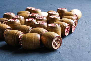 Vintage Lotto barrels are arranged in random order on a dark surface.