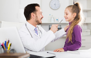 Male doctor and little girl