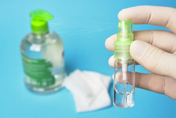 antiseptic sanitizer in a bottle with a spray in hand in rubber gloves.