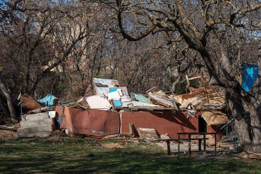 Totally Destroyed House With Bare Trees In The Background