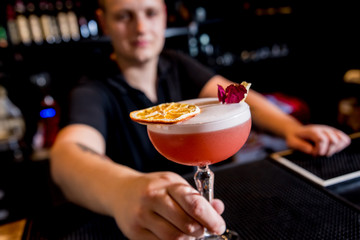 Bartender is making cocktail at bar counter. Fresh cocktails. 