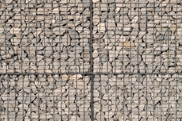 Abstract texture of light grey limestone gabion