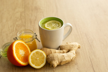 Tea with ginger, mint, lemon and honey on a white wooden table. Top view