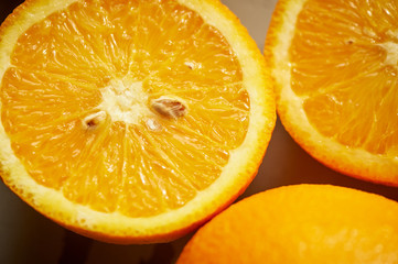 Close-up, cut orange with seeds. Juicy raw food.