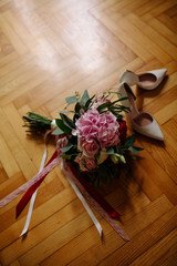 Beautiful white wedding bouquet with bride sitting in the background - shallow dof