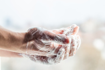 A man washes his hands with soap. Man's hands in foam with bubbles