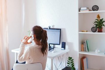 Work from home during coromavirus pandemic. Woman stays home. Workspace of freelancer. Office...