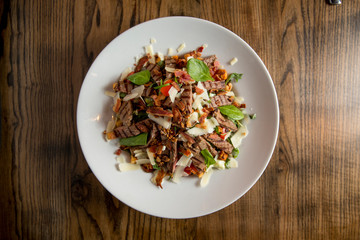 Beefsteak salad with lettuce, rocket,  and spinach with parmesan and .homemade spicy croutons