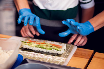 Children making sushi at the master class. Children, education and entertainment.