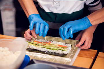 Children making sushi at the master class. Children, education and entertainment.