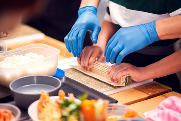Children making sushi at the master class. Children, education and entertainment.