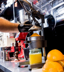 Metal manual juicer. Preparation of freshly squeezed orange juice