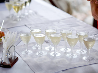 Many glasses with champagne on a white table