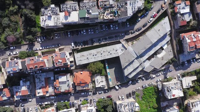 Corona Virus Pandemic, Aerial footage of Haifa, Israel, showing mid day empty  streets on central Carmel area.
