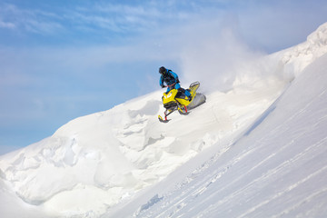testing of a new model of mountain snowmobile, prototype 2021. jump on a mountain snowmobile from a high ledge with the descent of a large avalanche. snowmobilers sports riding. Winter extreme