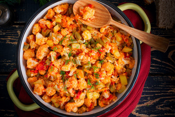 Vegetable stew with cauliflower, zucchini, celery, beans, carrots and onions, top view, selective focus