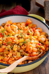 Vegetable stew with cauliflower in an enamel pan, selective focus