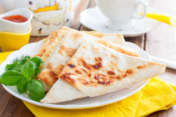 Envelopes in the form of a triangle of pita bread stuffed with cheese and herbs, selective focus
