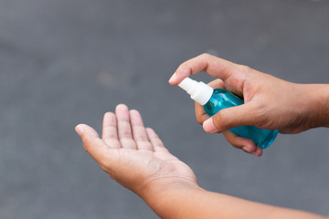 Man hands using alcohol spray for protection bacteria and virus .Coronavirus concept.