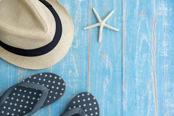 Tuinposter Beach accessories on blue wooden table. Summer concept © supat