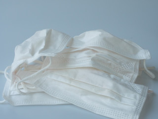 The used facial masks are stained and placed on the white background. The masks can be used as the tool to protect themselves from spreading airborne diseases like COVID-19 epidemic for everyday use. 