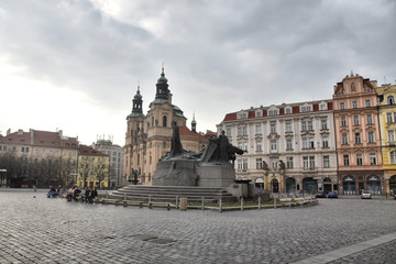Prague during quarantine caused by Corona virus,
statue of Jan hus behid Church of Saint Nicolas.