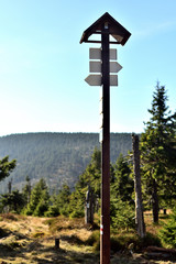 A tourist signpost telling tourists the right direction. Autumn mountain scenery