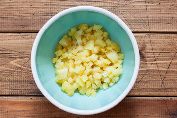 Step by step preparation of cold okroshka soup with sausage, step 2 - chopped boiled potatoes in an...