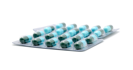 Close up on tablets and capsules pill in blister packaging, Pharmaceutical industry concept. Pharmacy drugstore, Amoxicillin capsule pills isolated on white background.